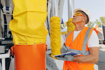 Hydraulic engineer doing safety check on new installation hoses pneumatic piston of industrial...