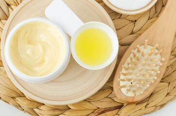 Fototapeta na wymiar Yellow facial mask (banana face cream, shea butter hair mask, body butter). Natural skin care and hair treatment concept