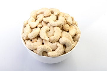 whole cashew nuts neatly arranged in a bowl against a clean white background