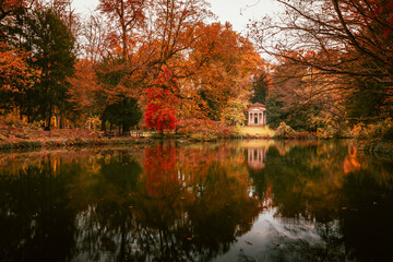 Monza park lake with its typical chapel in autumn during the foliage period