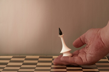 A person's hand places a chess king on the chessboard. The beginning of the game, the start of...