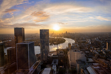 View from the financial district Canary Wharf to the urban London City skyline and Thames river during sunset time, England