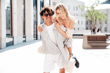 Young smiling beautiful woman and her handsome boyfriend in casual summer clothes. Happy cheerful...