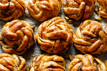 Traditional Swedish cardamom swirl buns - kardemummabullar, focus on the bun inside. Homemade sweet...