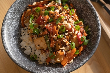 Bowl with tasty rice, meat and vegetables closeup