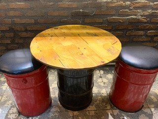 Red gallon bucket seat with black pillow. Industrial style furniture