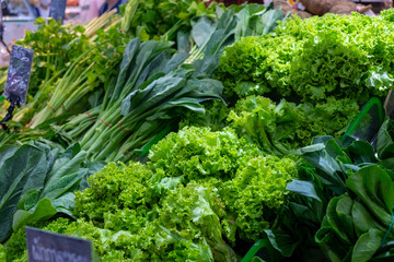 fresh green vegetables on stall in the market