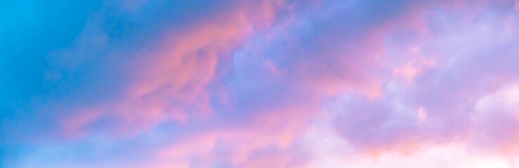 Blue morning sky is in pink clouds. Sunrise clouds are in vanilla colours. Beauty in nature. Twilight time, golden hour. Details of evening sunset. Natural abstraction. Peace concept. Panoramic view