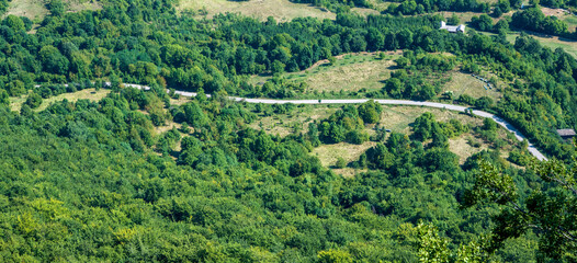 Fototapeta na wymiar Road surrounded by wooded slopes of Stara planina National park.