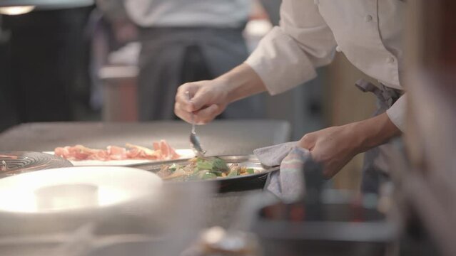 Kitchen staff working in the restaurant making delicious food recipes
