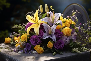 Fotobehang Gerbe de fleurs colorées posées sur une tombe pour décorer le cimetière © Leopoldine
