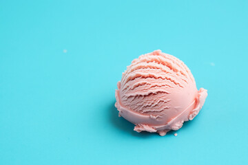 Scoop of pink ice cream on blue background. Minimal style.