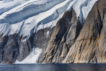 Antarctic landscape with icebergs, fjord and ice