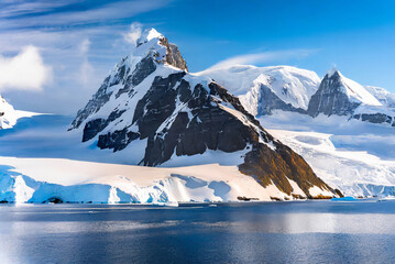 Antarctic landscape with icebergs, ice and snowflakes