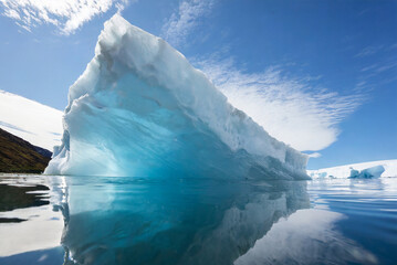 The image captures the breathtaking beauty of Antarctica's ice-covered landscape, where majestic...