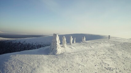 Top view of winter landscape with stone pillars. Clip. Miracle of nature on plateau with stone pillars in snow on winter day. Stone pillars in snow on background of horizon and winter mountains