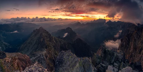 Papier Peint photo Tatras Sunrise at Rysy peak in Tatra Mountains with rocky foreground. Colofrul sky with clouds in early morning. Slovaki and Poland border at the top.