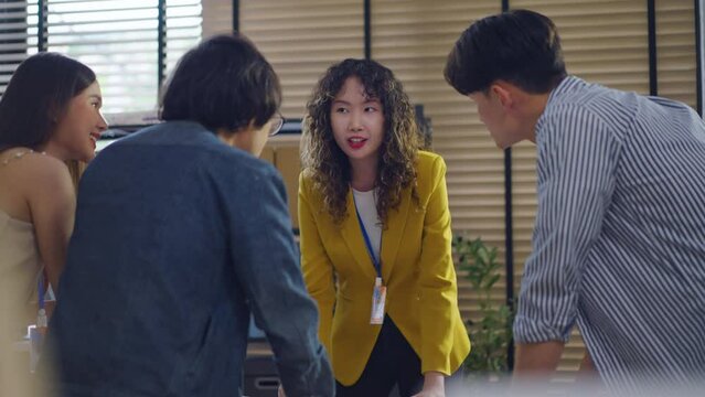 Asian Businesswoman make inspiration, motivating ,encouraging and instilling enthusiasm within her team to Increase morale for employees and boost productivity and drive sales success.