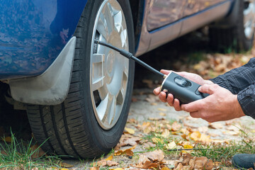 Inflating car tires with a portable wireless air pump outdoor