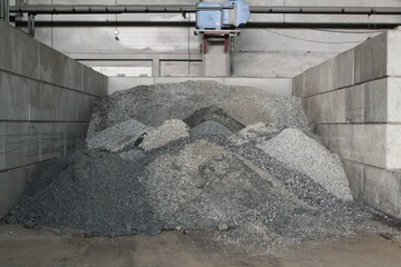 Pile of natural crushed stone ore on industrial factory. Mining and quarrying industry plant