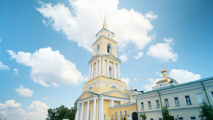 Low angle view of yellow Cathedral building on a blue cloudy summer sky background. Clip. Orthodox architecture theme.