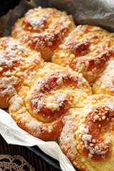 Close up view of homemade spiral cheese sweet rolls with butter crumble, focus on the bun inside.