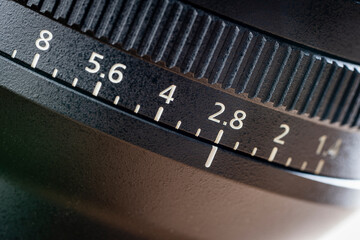 An new camera lens, closeup. The lens, focus and exposure controls of a mirrorless camera, macro