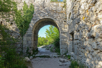 Ancient buildings cave fortress city Mangup-Kale, sunny day. Mountain view from the ancient cave town of Mangup-Kale in the Republic of Crimea, Russia. Bakhchisarai.