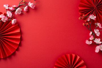 Lunar New Year vibes captured: Overhead shot featuring fans, Feng Shui essentials, and sakura...