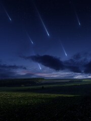 Falling meteorites. Night view of the sky with meteor shower. Landscape with fields and shooting...