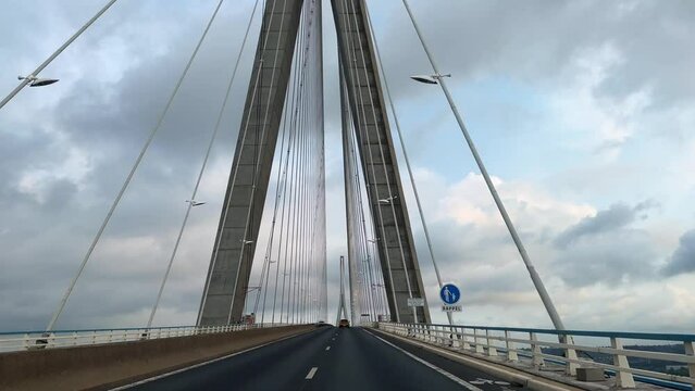 Normandy Bridge in France, River Seine Panorama, Point of view car driving along the road La Manche, English Channel 4k. Highest cable Pont de Normandie still standing tall. 