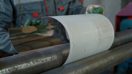 Automated machine shapes the metal sheet at the industrial plant. Creative. Machine is bending the...