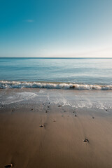Waves gently wash onto the sandy shore
