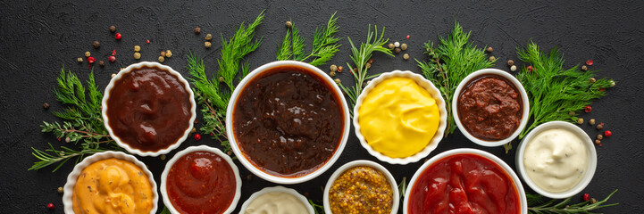 Different types of sauces in bowls with seasonings banner, rosemary and dill, thyme and and...