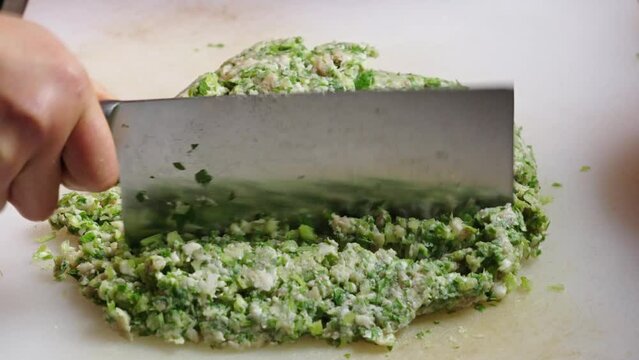 Chop the meat with kitchen knife to make the dumpling stuffing