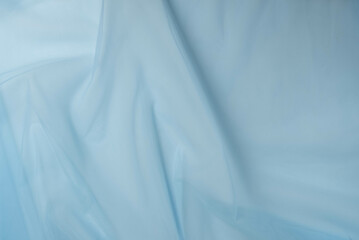 Blue tulle fabric texture top view. Blue background.