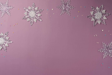 Snowflakes on a purple background and space for text