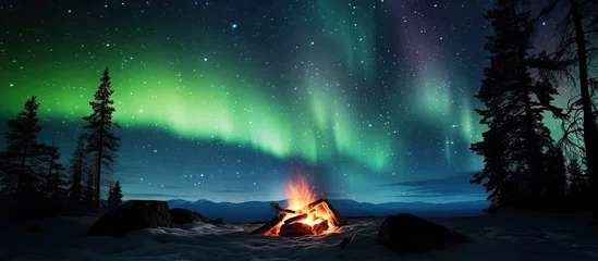 Fotobehang Composite photo showing a comforting campfire under starry Northern Lights © Vusal