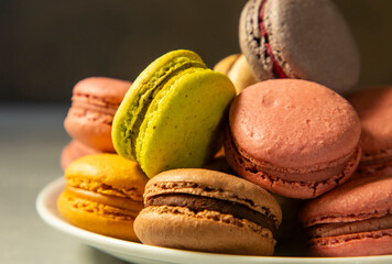 Close-up of macarons cakes of different colors in blue background. Culinary and cooking concept. Tasty colourful macaroons.