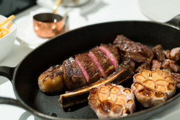 Juicy steak sliced on the cast iron