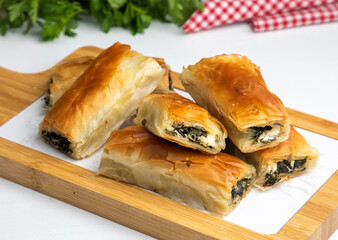 Traditional delicious Turkish food; Handmade Spinach Cheese Pie - pastry, Turkish name; el acmasi borek, rulo borek. Turkish borek rolls with spinach and cheese