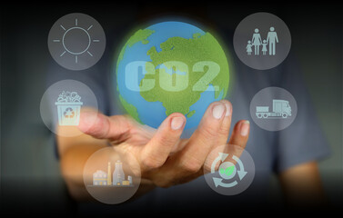 A person holds a globe as a comparison in terms of carbon footprint in examining the impact in world.carbon Emissions,Environmental Impact,Climate Footprint,Carbon Impact,Greenhouse Gas Footprint