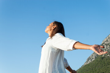 Somatic exercises, happy beautiful woman on the beach, advertising photo