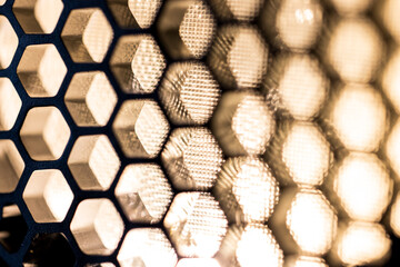 Macro shot of a honeycomb grid in front of a flash 