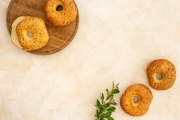 Homemade baked bread bagels on wooden board. Healthy breakfast background