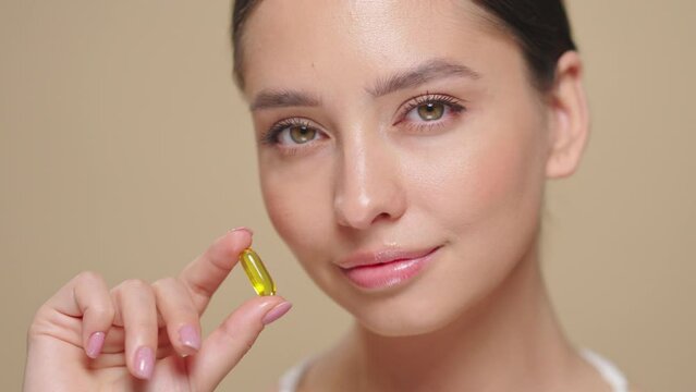 Vitamins. Close Up Of Happy Beautiful Girl With Pill With Cod Liver Oil Omega-3. Nutrition. Vitamin D, E, A Fish Oil Capsules. Healthy Lifestyle. Sport, Diet Concept