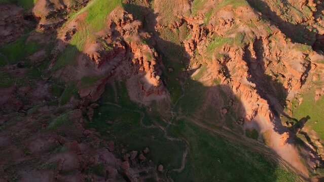 erzurum narman fairy chimneys green grass on red soil aerial view 4K