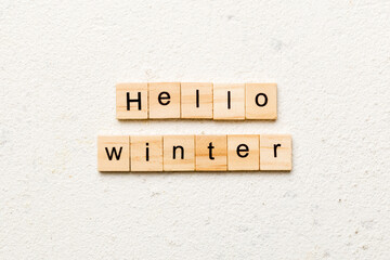 hello winter word written on wood block. hello winter text on cement table for your desing, concept
