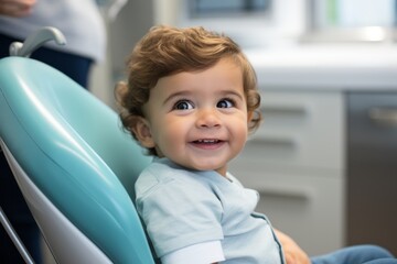 Baby boy is sitting on dental chair and smiling, healthy teeth, prevention of caries in children - obrazy, fototapety, plakaty