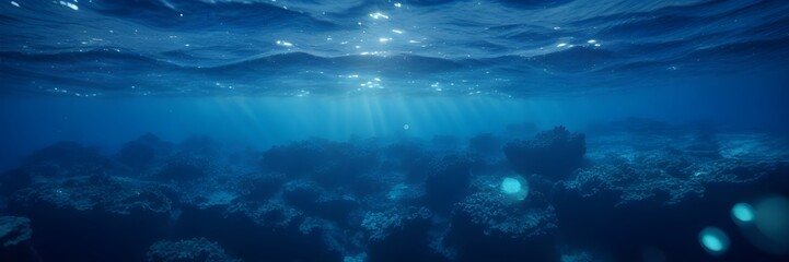 Fototapeta na wymiar Blue Underwater Background with Piercing Sunlight and Subtle Bokeh Lights Banner.